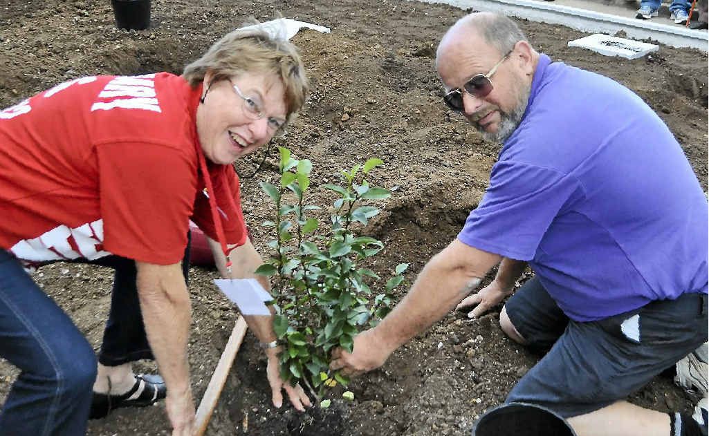Margaret Bryant and Greg Marsh plant a tree outside the front of the school. Margaret Bryant and Greg Marsh plant a tree outside the front of the school.
